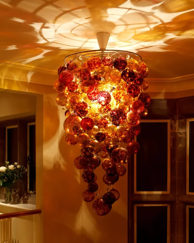 A large, glass, Roast pendant lights the stairs and upper hallway