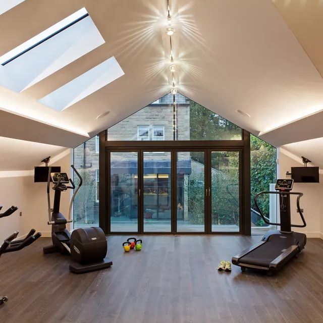 Cove lighting and a track lighting system in a private gym