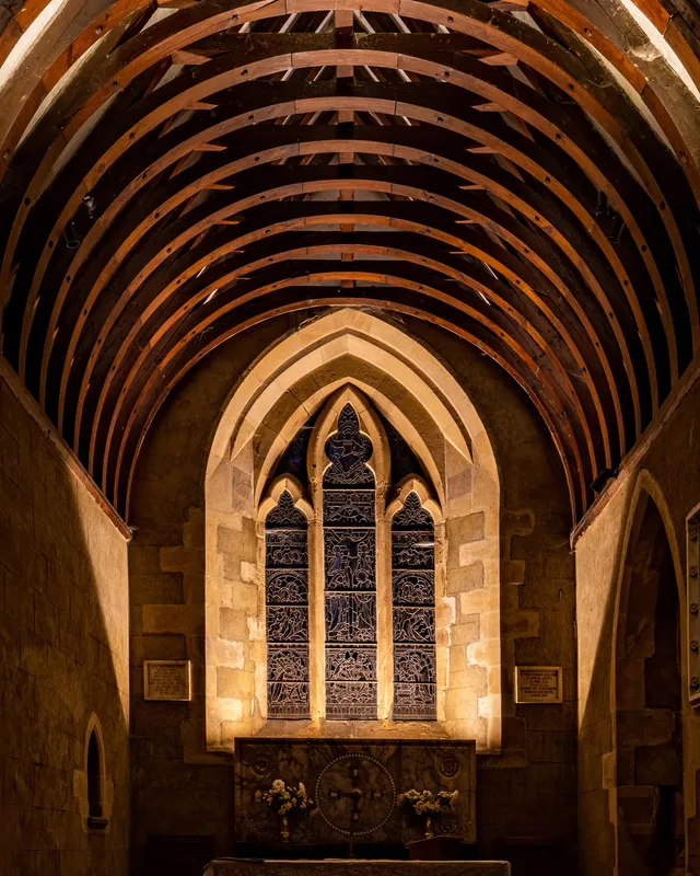 Discreet LED light fittings highlighting the altar and chancel window