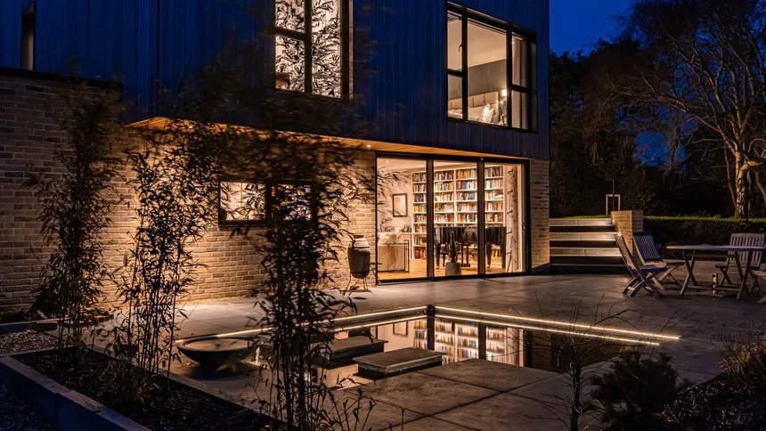 Downlighting, sublte LED linear linear lighting in the pool and accent lighting on the steps and trees