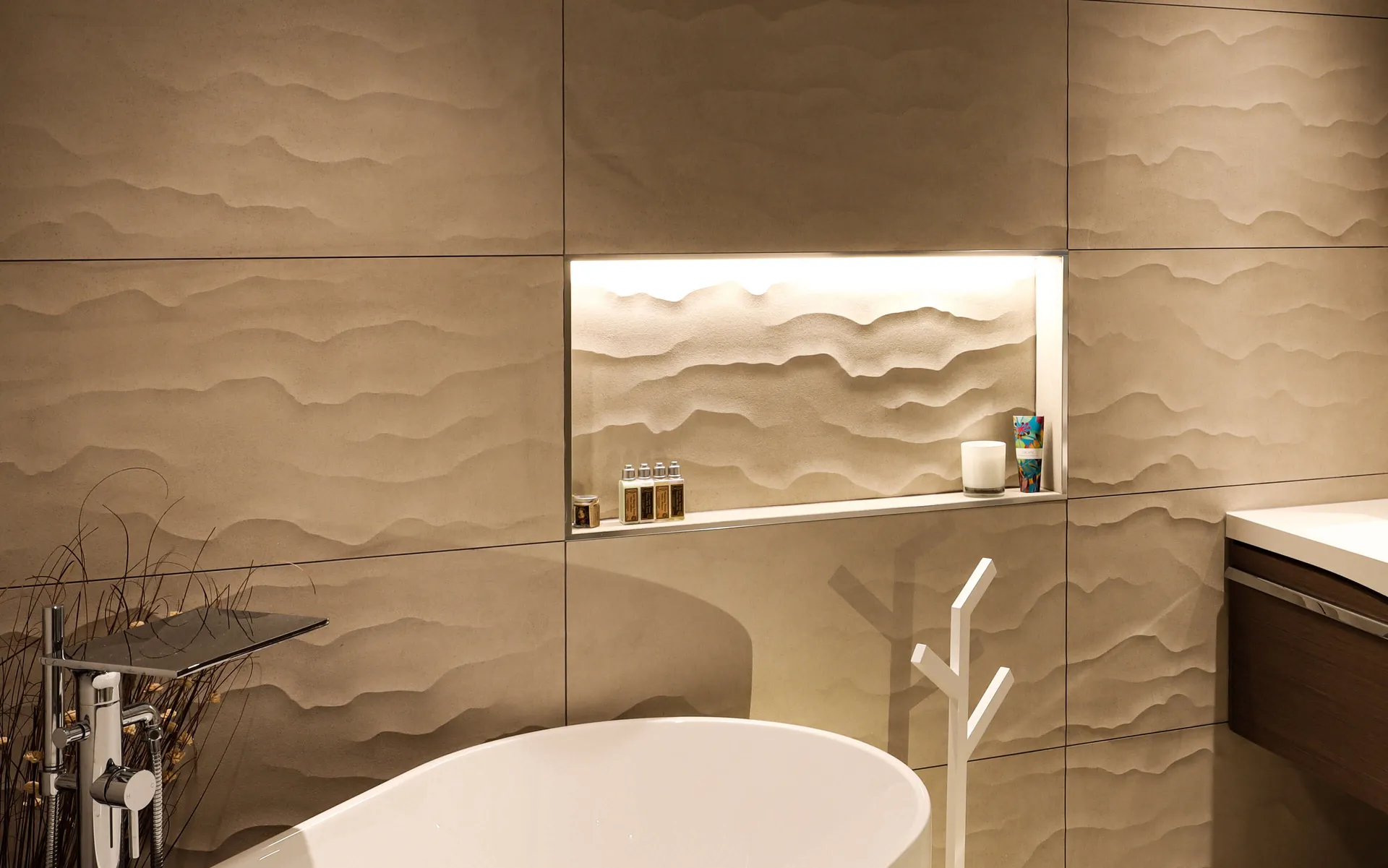 Downighting and lighting in the niches of a beautifully textured moden bathroom