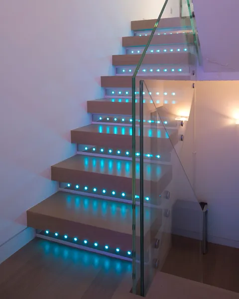 Custom colour changing fittings set into the risers of a modern stone staircase