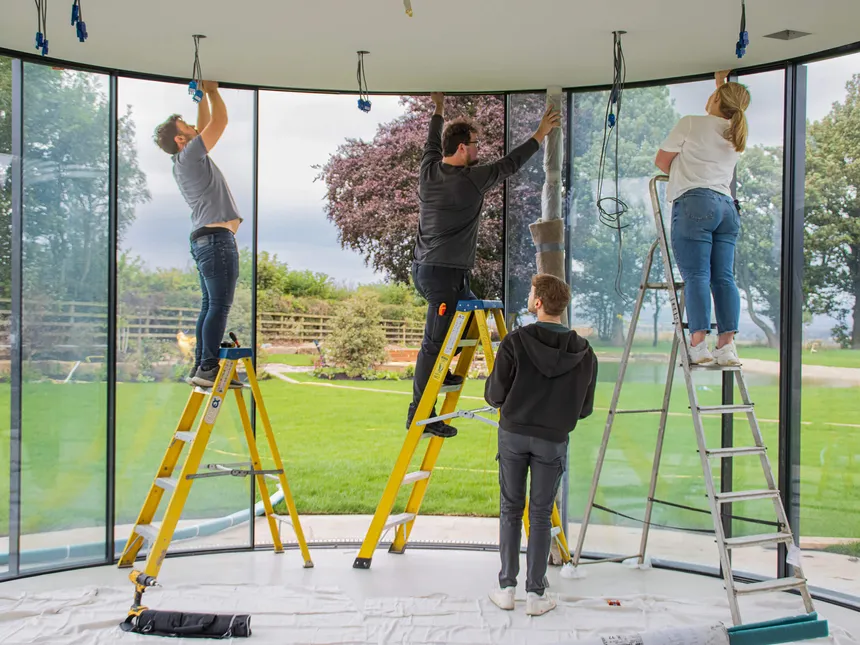 Matt, Joe and Fran securing an electric curtain track with Kieran watching on