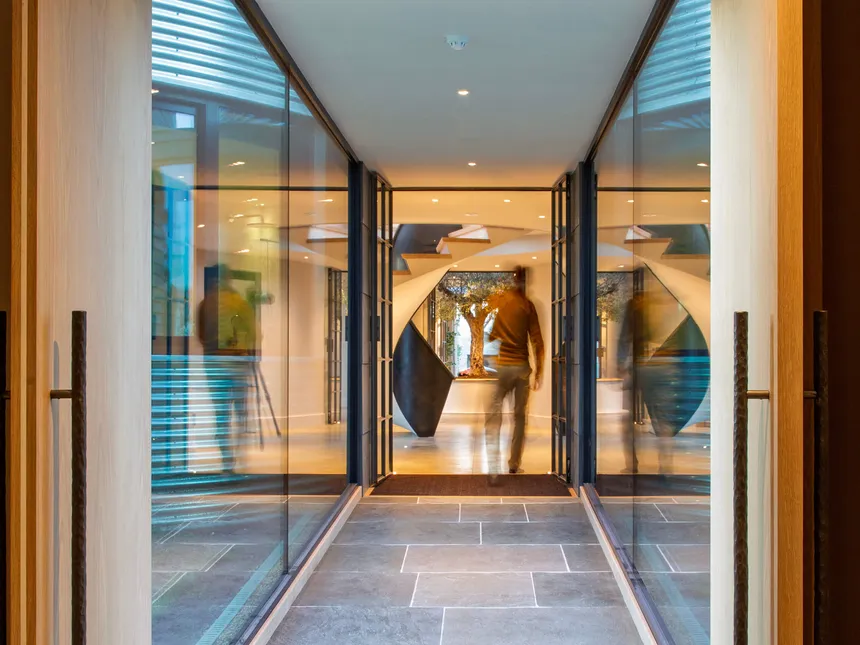 Shot through a glazed corridor with another photographer setting up a shot.