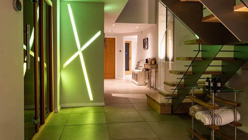 Coloured LED lighting in the hallway leading to the gym, sauna and music room