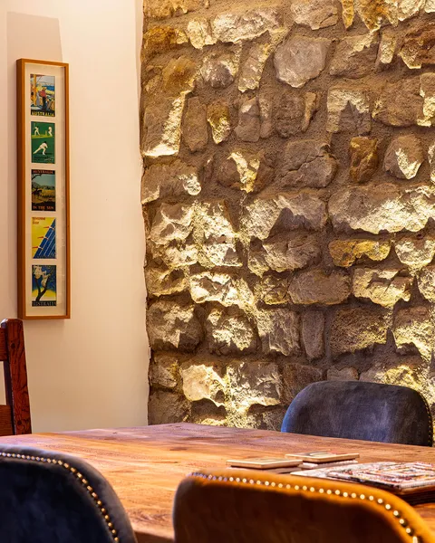 Upighting effect on a stone wall behind a dining table