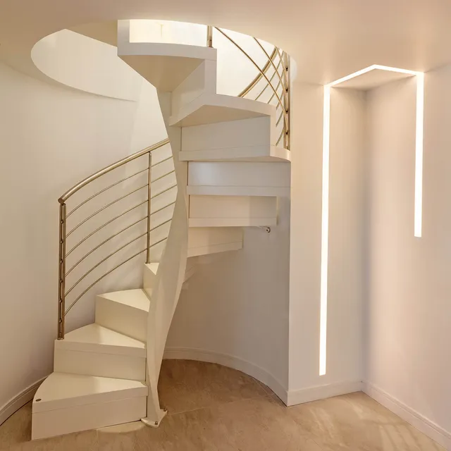 Inset LED linear profile fitting next to a spiral staircase