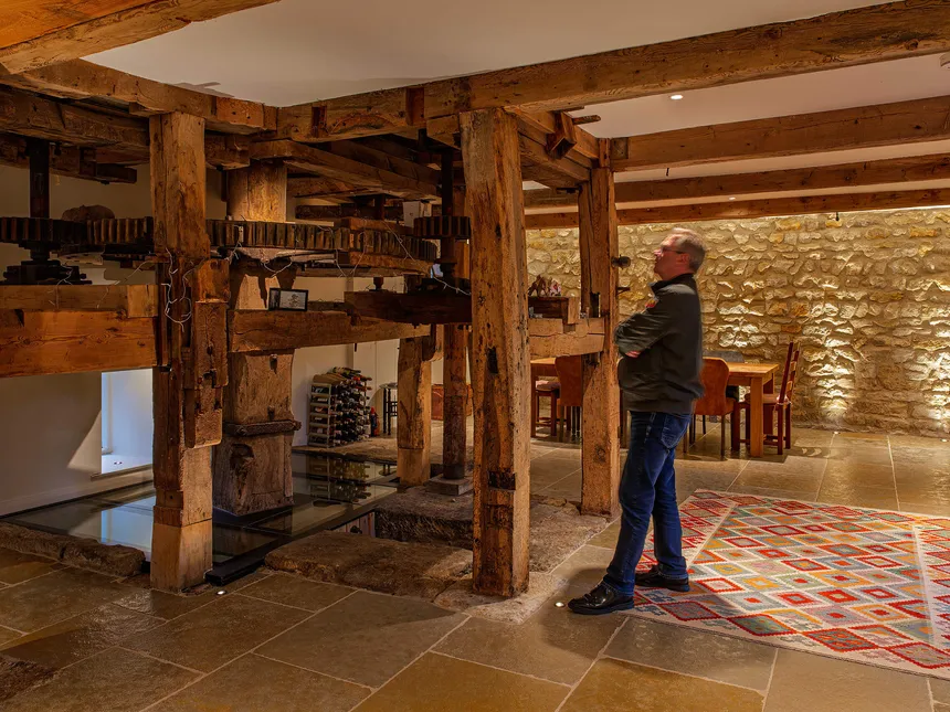 The photographer reviewing the ancient watermill machinery in a converted watermill