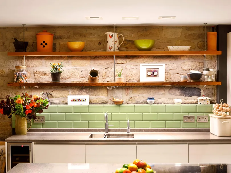 Brightly lit kitchen work surface with downlights and undershelf LED linear fittings