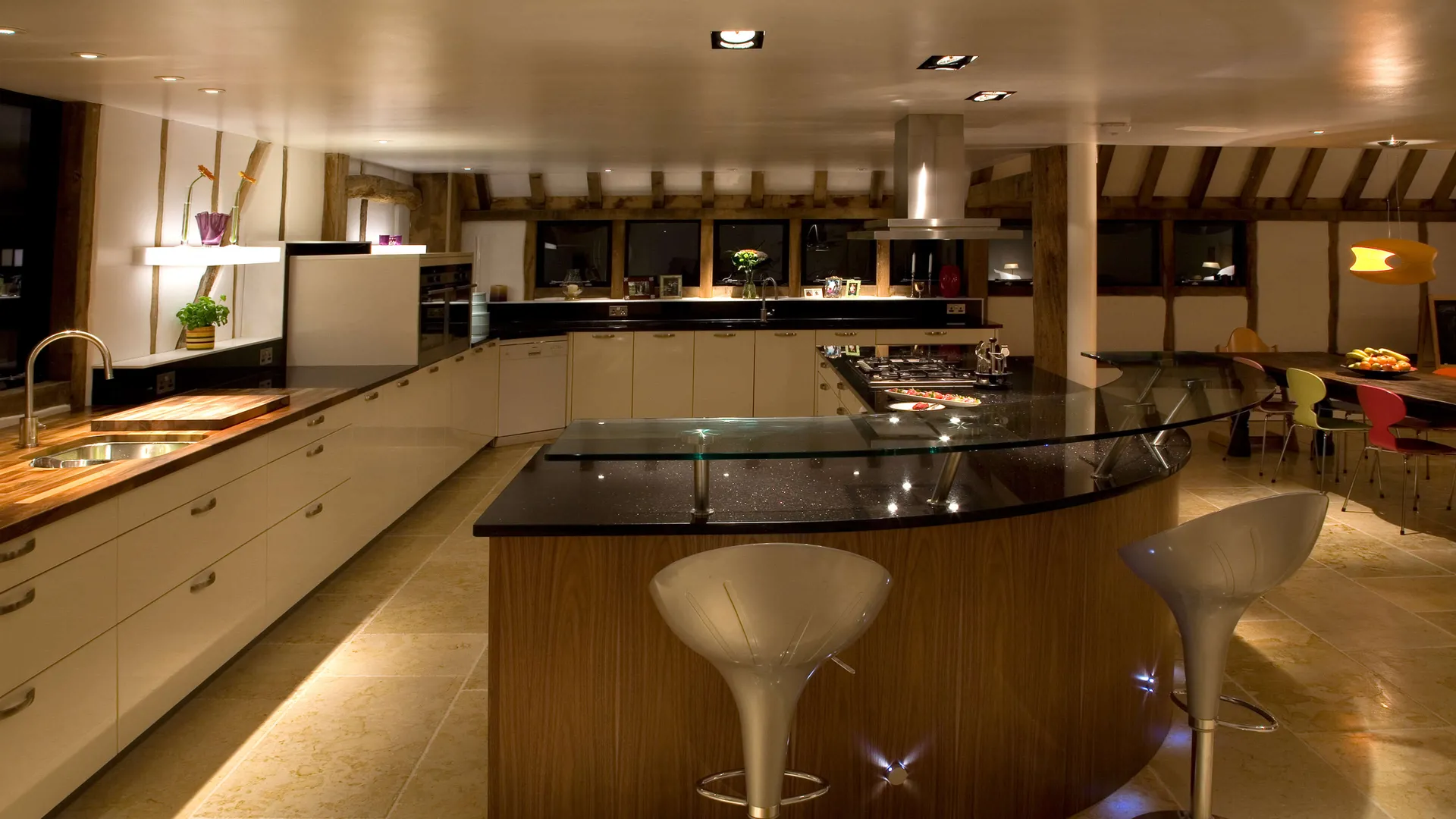 The kitchen dining area of a Salisbury barn with lit shelves, fun decorative fittings and excellent task lighting over the working areas