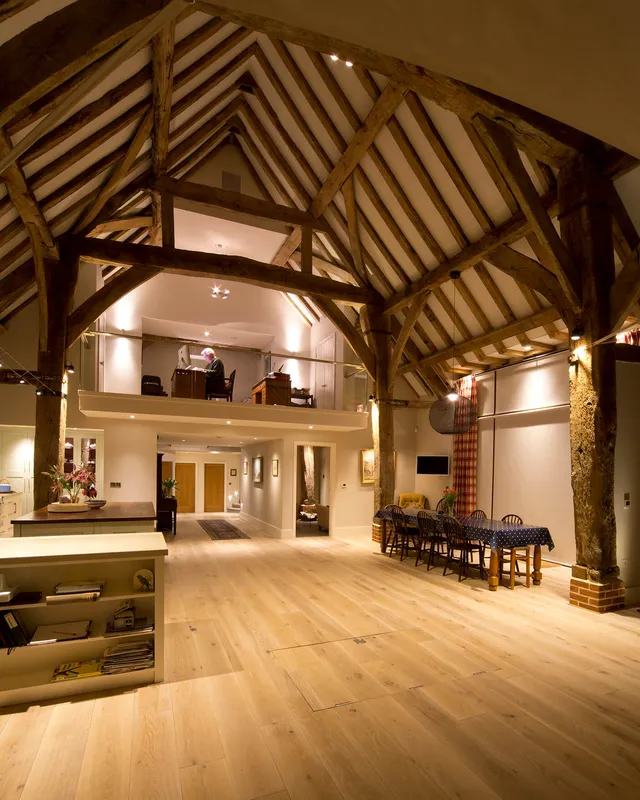 A mezzanine floor office in a vast triple height barn 