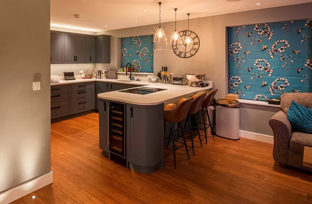3 glass pendants hung above a stylish modern grey kitchen island
