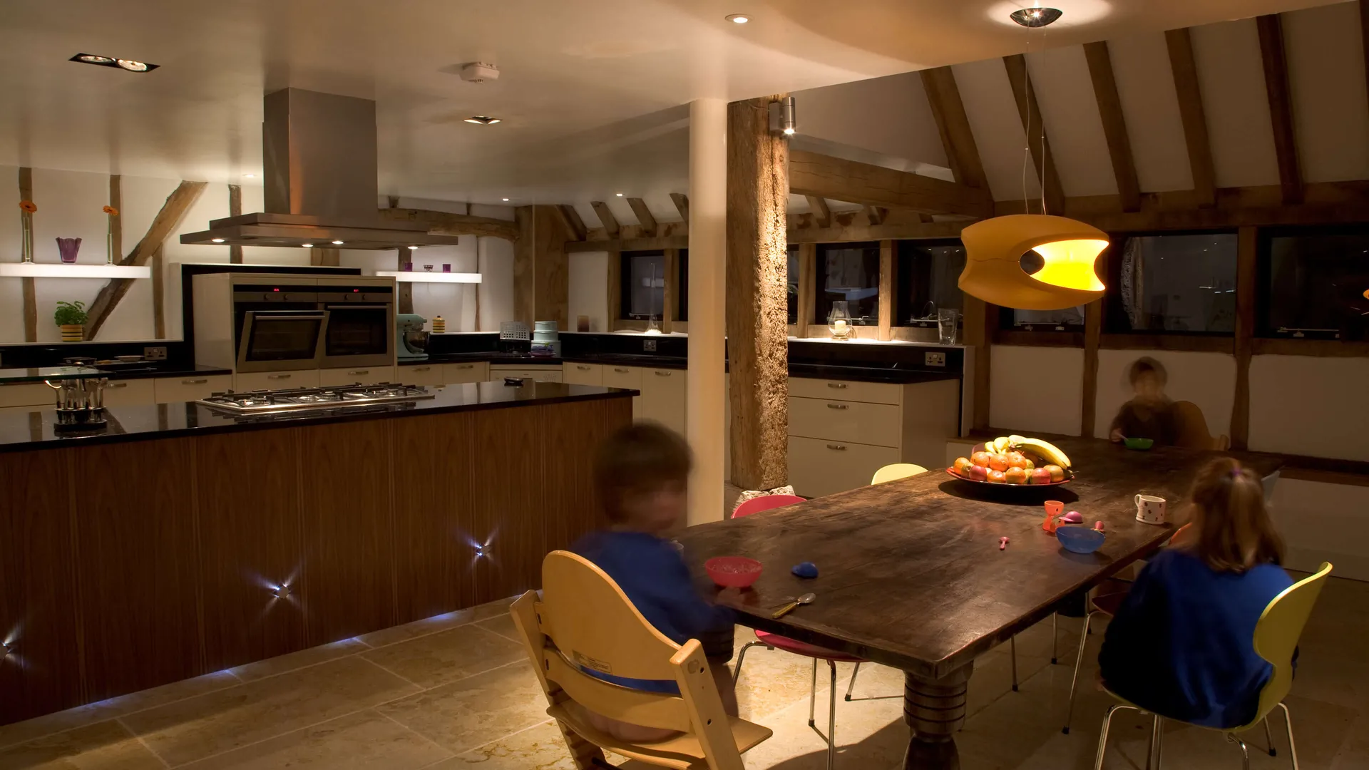 The kitchen dining area of a Salisbury barn with lit shelves, fun decorative fittings and excellent task lighting over the working areas