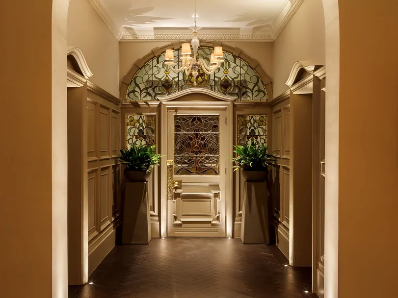 An Edwardian entrance porch and hallway with accent lighting and classic contemporary pendant in bright welcome mode