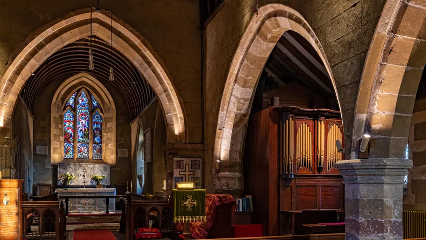 Surface mounted LED fittings lighting the chancel, arches and organ in a country church