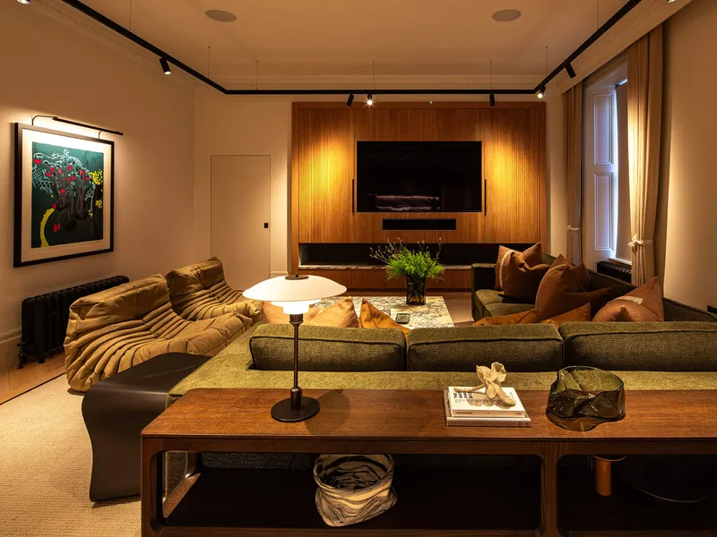 A luxurious comfy snug for games, TV and chilling.  The space is lit with flexible track lighting