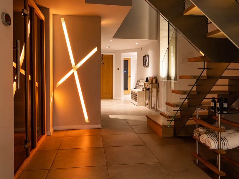 Colour changing recessed linear LED lighting in a new-build house, gold