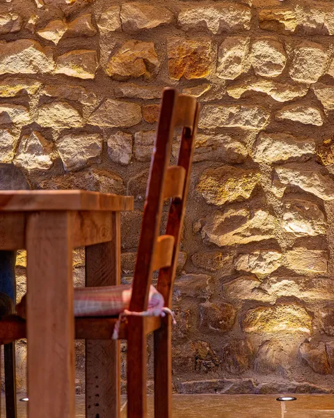 Stone wall with in ground lighting with dining table