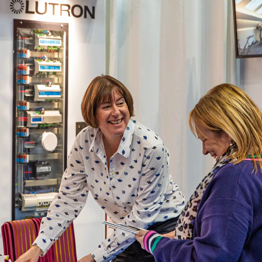 Mel and a visitor talking on the Brilliant Lighting show stand at the NEC in 2025