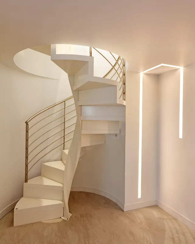 Inset LED linear profile fitting next to a spiral staircase