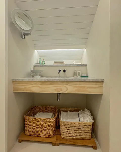 linear lighting detail behind a basin in a small Scandi style bathroom