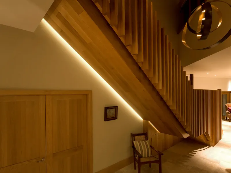 Shadow gap lighting for a spectacular wooden staircase