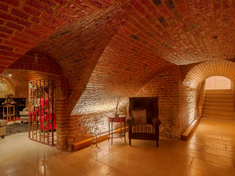 Arched red brick cellars with a bar and wine cellar