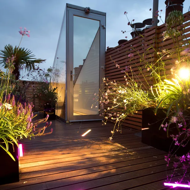 Colour-changing LED linear fittings set into the decking of London townhouse roof garden