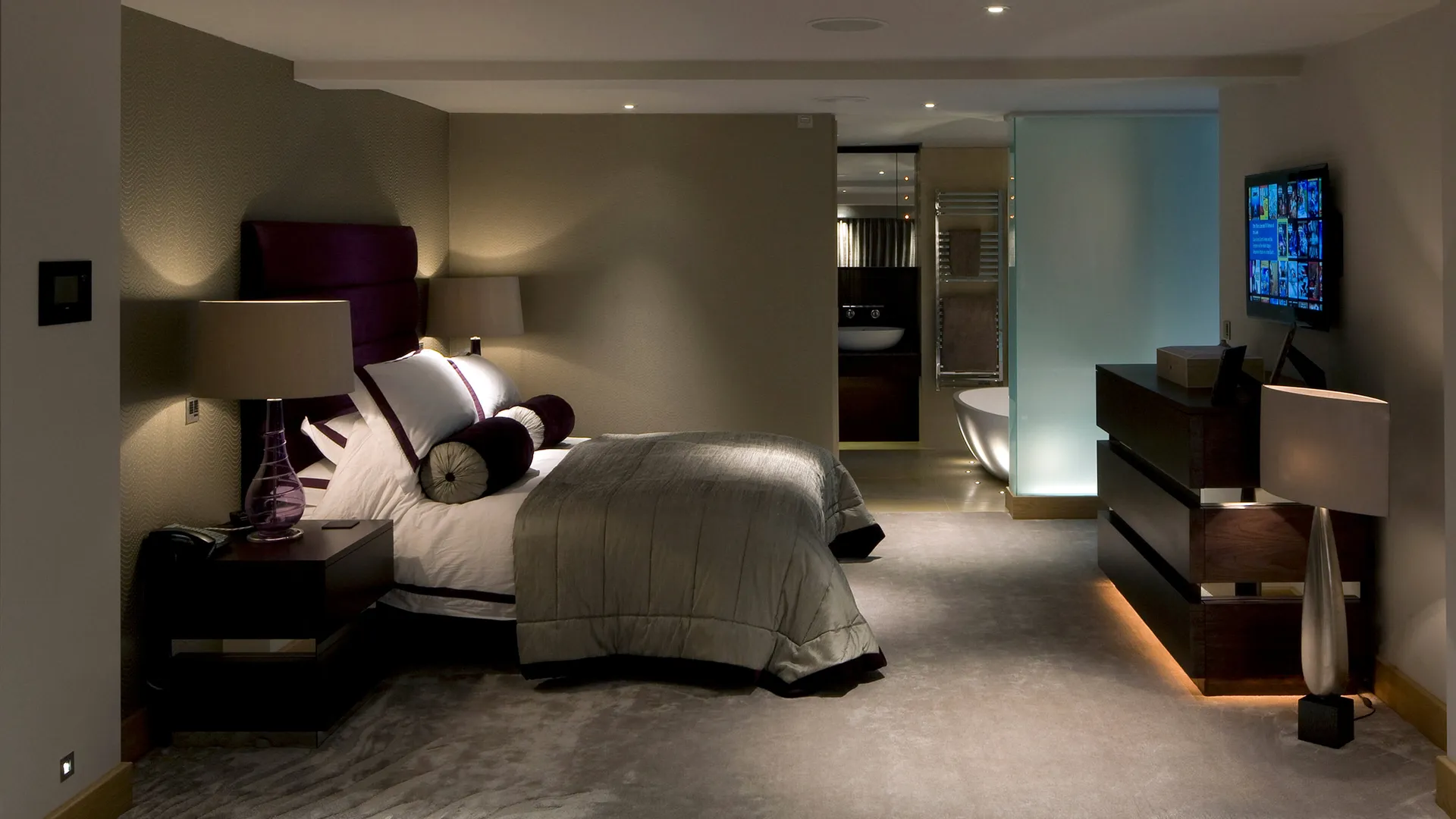 A luxurious bedroom suite with a subtle accent lighting