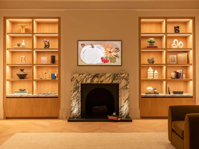 Downlit shelving in a contemporary snug.  Linear LED fittings recessed into the underside of wooden shelves.