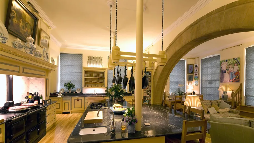 Custom lighting for a kitchen in a stately home with linear LED fittings and concealed downlights in a pan rack