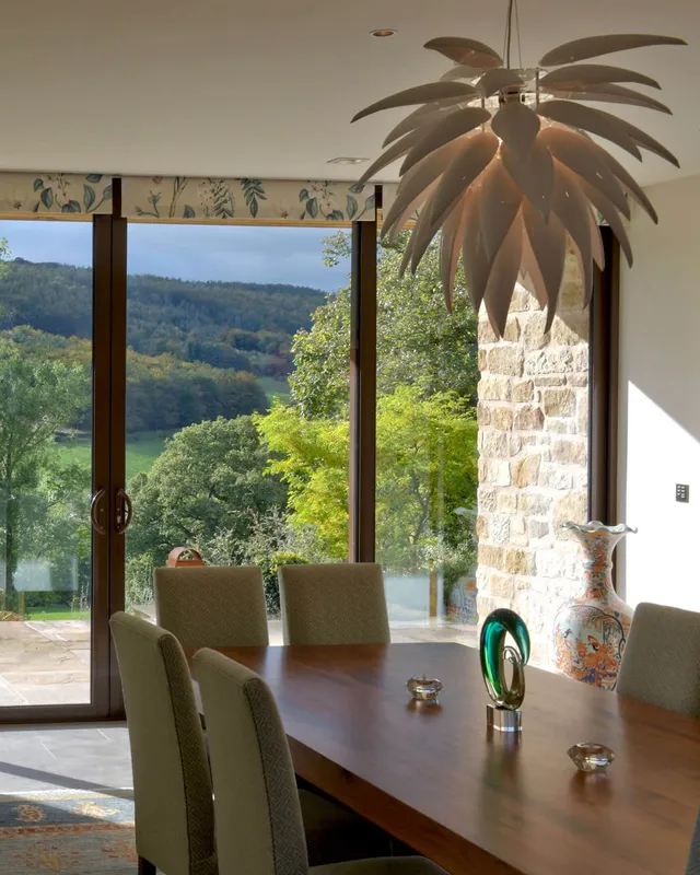 A dining room on a suuny day with Lutron electric blinds raised