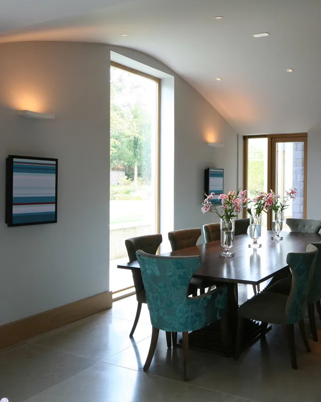 A barrel ceilinged dining room with uplights and Artcoustic speakers