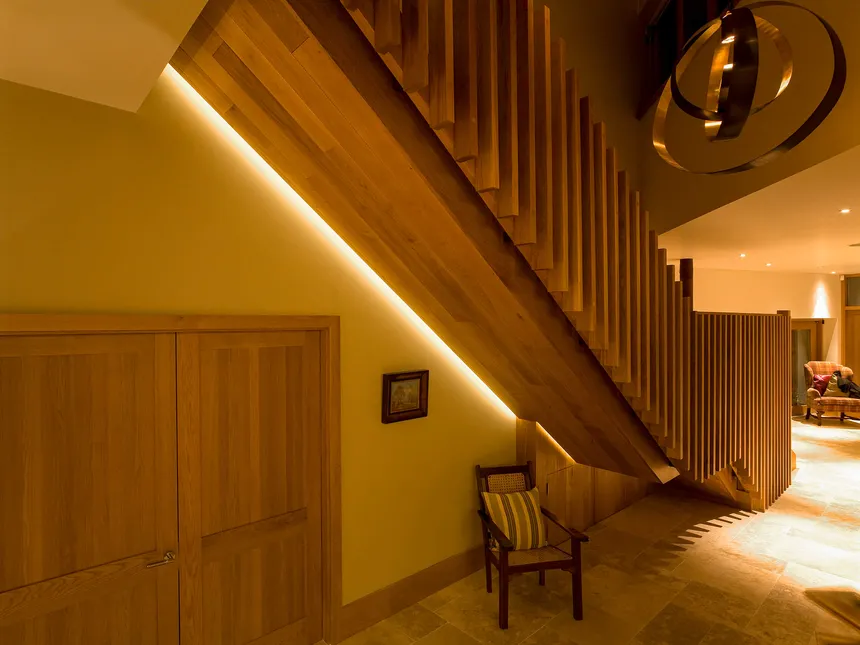 Shadow gap lighting for a spectacular wooden staircase