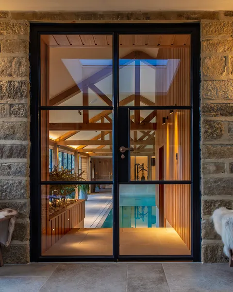 View on an indoor pool room through a glass door