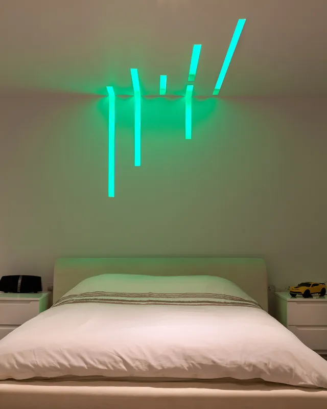 Colour-changing LED linear fittings in Sedap profiles in a teenager's bedroom 