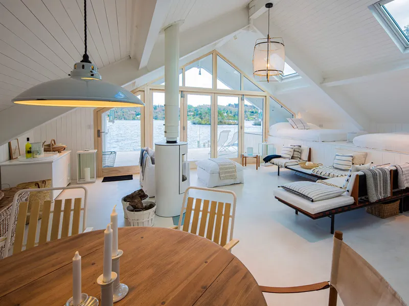 Daylight shot of a Scandi style boathouse looking out towards the lake