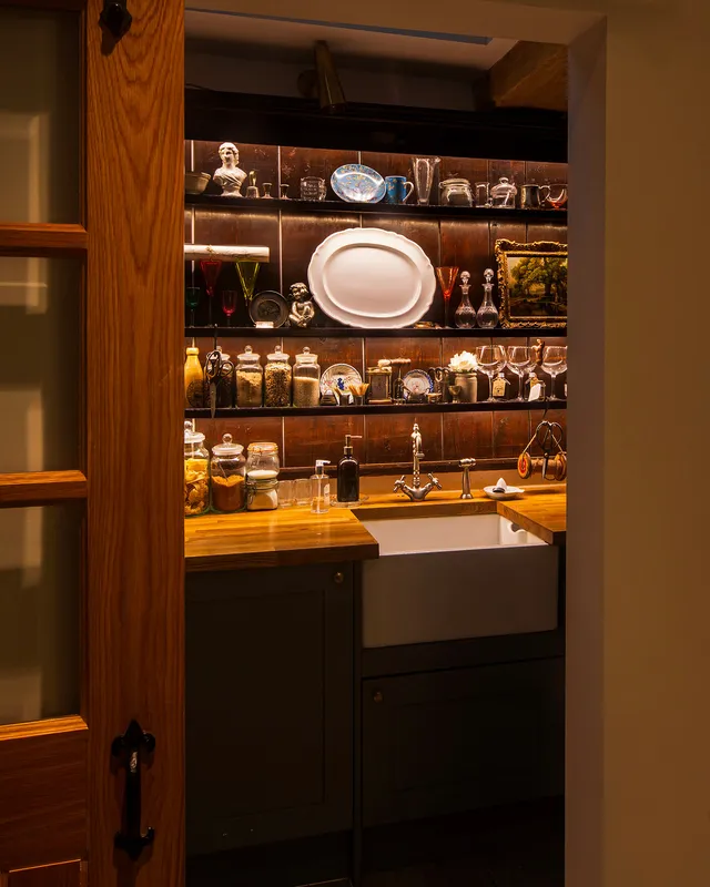 A small pantry with bright shelf lighting