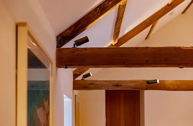 Bronze surface mounted spotlights mounted on wooden beams