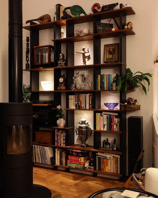 Shelving for books and objets d'art lit with miniature spot lights recessed into the shelving