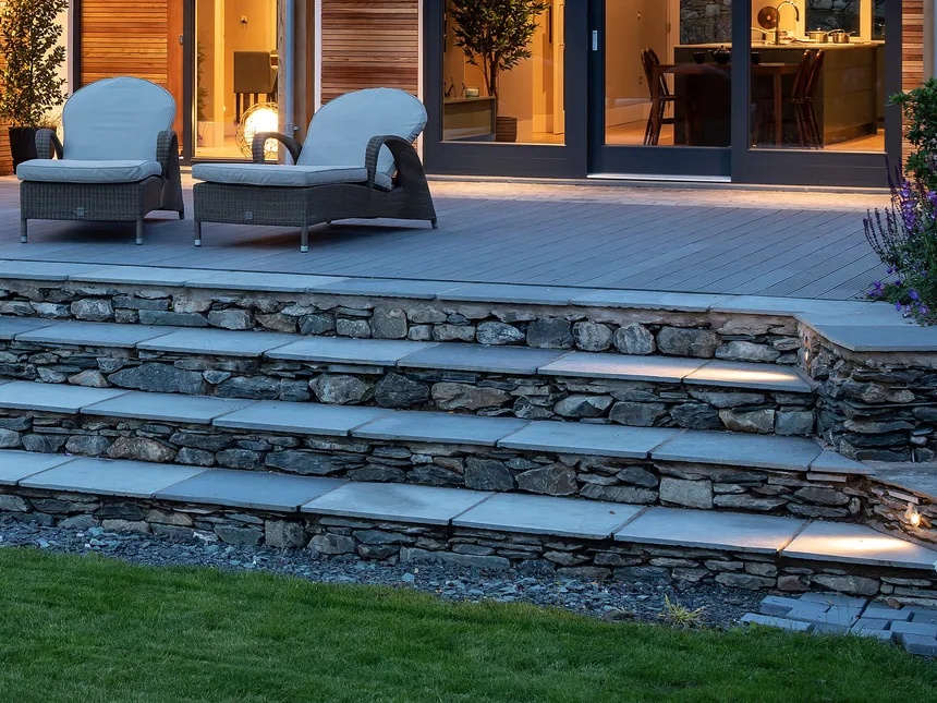 Small LED accent lights lighting the stone treads in a Lakeland garden lighting design