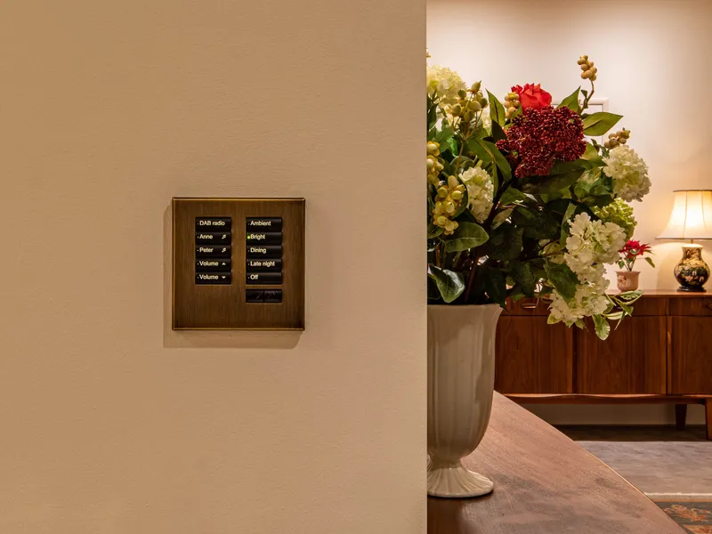 An antique bronze Lutron seeTouch keypad with lighting scenes and audio control