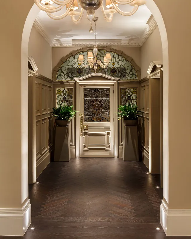 An Edwardian entrance porch and hallway with accent lighting and classic contemporary pendant