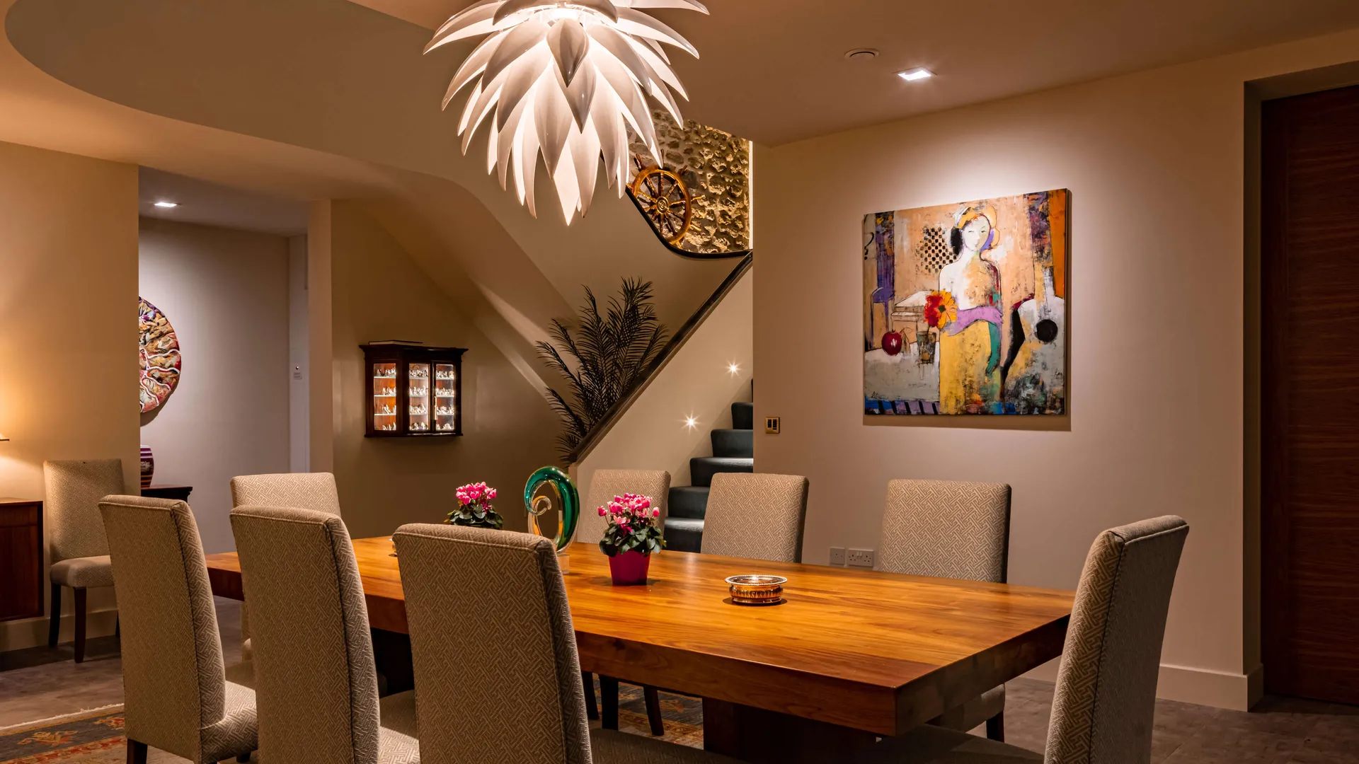 Dining room lighting with accent lighting on the stairs and feature wall