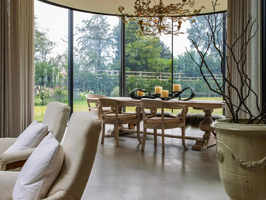 Lutron electric curtain tracks in a striking moden circular glazed dining room