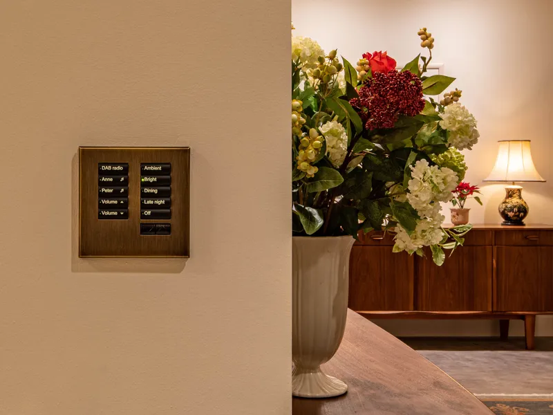 An antique bronze Lutron seeTouch keypad with lighting scenes and audio control