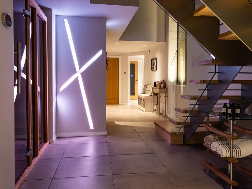 Colour changing recessed linear LED lighting in a new-build house, white