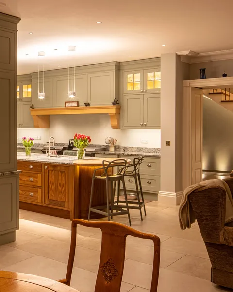 A beautiful kitchen with Occhio pendants over the large central island