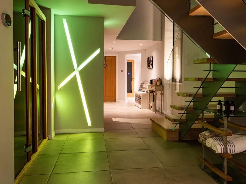 Colour changing recessed linear LED lighting in a new-build house, lime