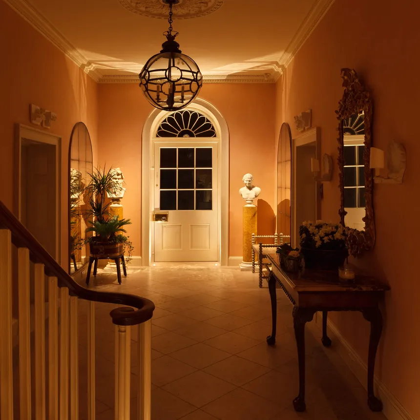 Accent lighting for the doorway and a pair of busts in a beautiful Georgian entrance hall.